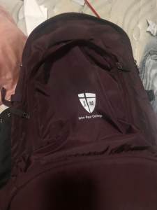 John Paul college backpack and brand new in plastic house sports shirt
