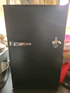 Bar fridge suits man cave with beer opener at the front 