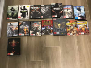 Various PC game boxes with discs and manuals
