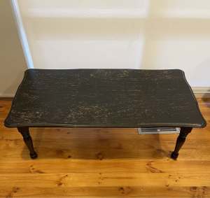 Black four-legged rectangular coffee table