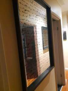 Large framed mirror with italic writing 