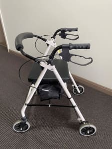 White four wheeled walker with seat in excellent condition