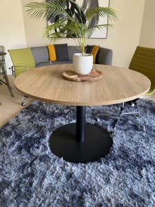 Round timber and black dining table