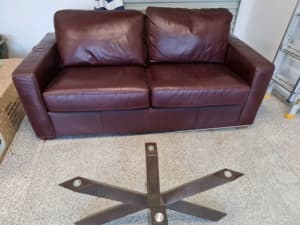 Rich red leather couch with fold out double bed