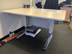 Drafting desks with power height adjustments
