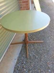 Round Green Laminex Table on wooden pedestal leg