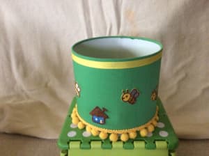 Decorative children’s green lampshade with bees & yellow Pom Pom base