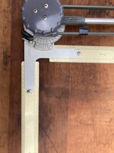 vintage drafting board with drawing machine and rulers