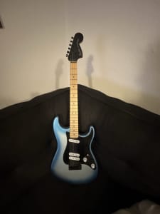 A Squire Stratocaster Electric Guitar