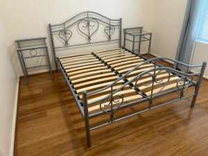 Double bed with two matching glass top side tables.