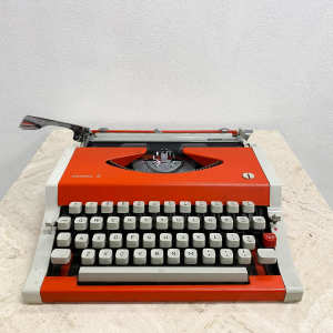 Vintage orange Olympia Olympiette 3 portable retro typewriter