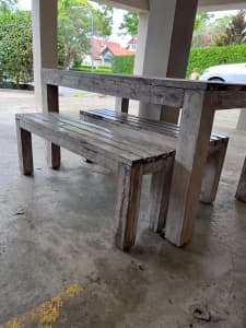 Wooden outdoor table with bench seats