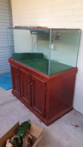 Aquarium/reptile enclosure on timber cabinet, accessories included.
