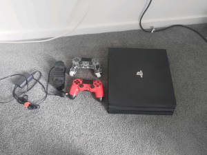 PLAYSTATION 4 PRO W/ TWO CONTROLLERS AND CRADLE