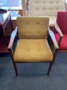 Stunning vintage wooden armchair with green cushioning 