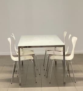 White glass dining table with 6 white chairs