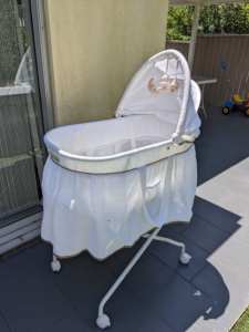 Love n Care bassinet on wheeled stand with storage shelf below