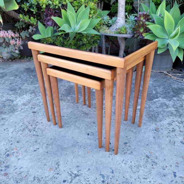 Nest of 1950s black glass top side tables, restored. Buffets & Side