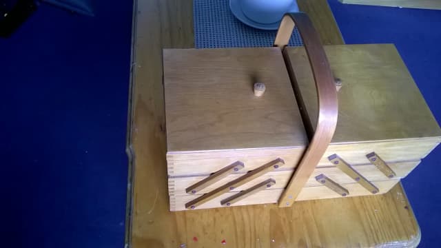 Cantilever Sewing Box including numerous threads and accessories. | Art