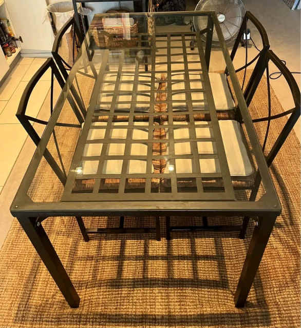 Metalic glass top table with natural rush chairs Dining Tables