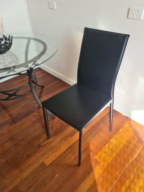 four black dining chairs