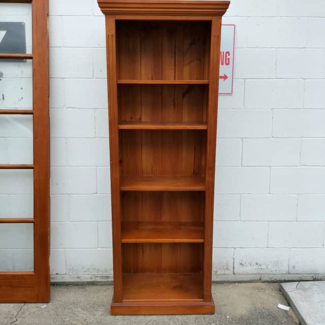 Four tier timber bookcase with adjustable shelves. Bookcases