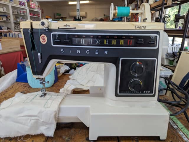 Diana playing with clearance toy sewing machine