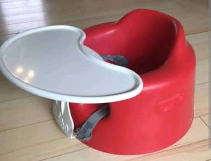 red bumbo seat with tray