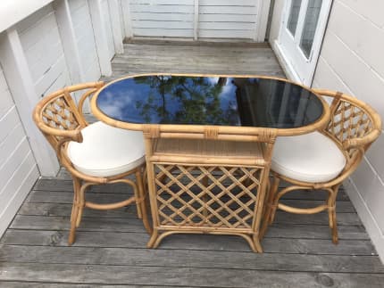 cane table and two chairs